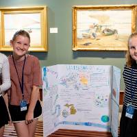 students posing with their poster